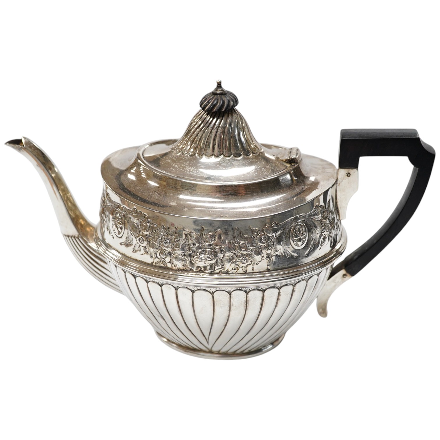 A late Victorian silver half fluted and floral embossed teapot, John Round & Sons, Sheffield, 1895, gross weight 22.8oz. Condition - poor.